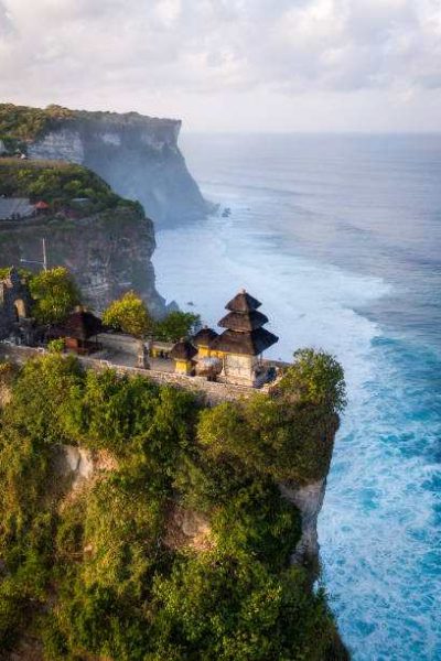 Bali, Indonesia, aerial view of Pura Luhur Uluwatu temple at sunrise.